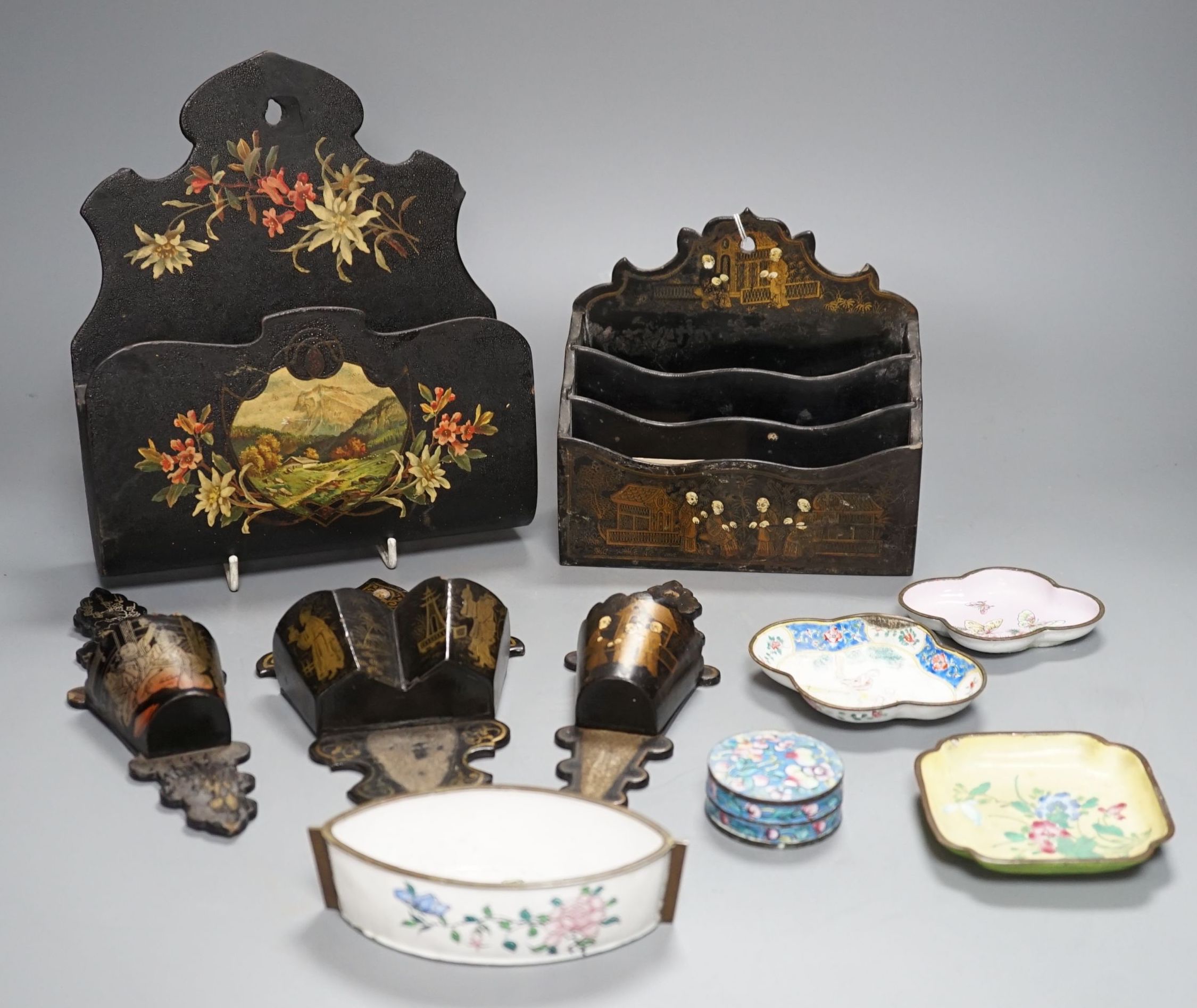 A group of five Chinese lacquered papier mache wall pockets, enamelled dishes, etc.